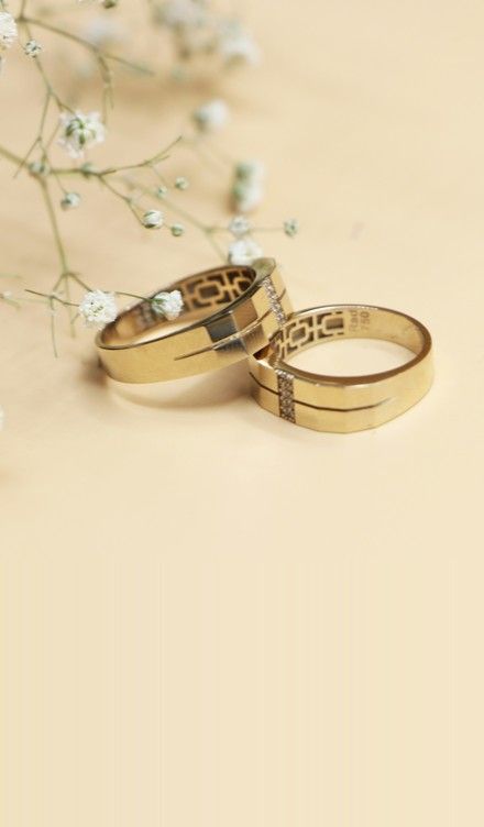 Silver and gold rings on a white surface